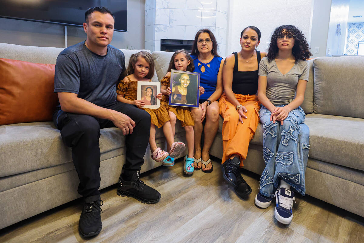 Aaron, from left, Aria, Ava, Norma, Vanessa and Diamond Aguilar pose with a photograph of Savan ...