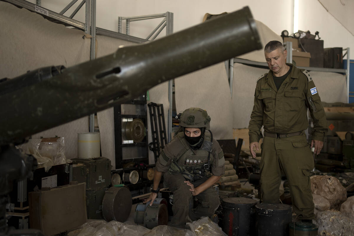 An Israeli soldier from an EOD (explosive ordnance disposal) unit, left, and an officer from th ...