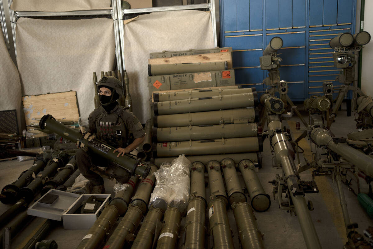 An Israeli soldier from an EOD (explosive ordnance disposal) poses with a weapon used by Hezbol ...