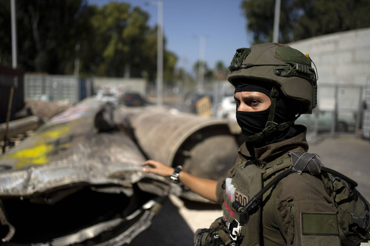 An Israeli soldier from an EOD (explosive ordnance disposal) unit gestures to Iranian ballistic ...