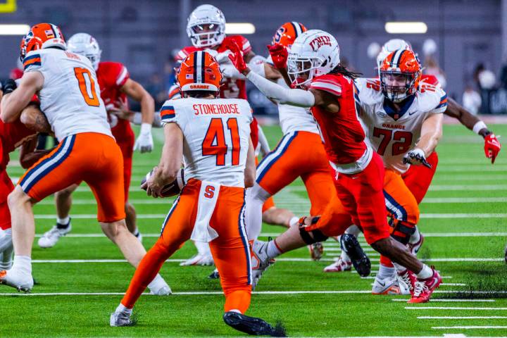 Syracuse Orange punter Jack Stonehouse (41) is unable to punt as UNLV wide receiver Ricky White ...