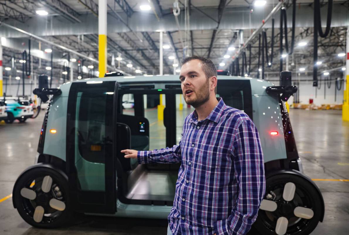 Justin Windus, director of operations for Zoox, speaks to media in front of the autonomous Zoox ...