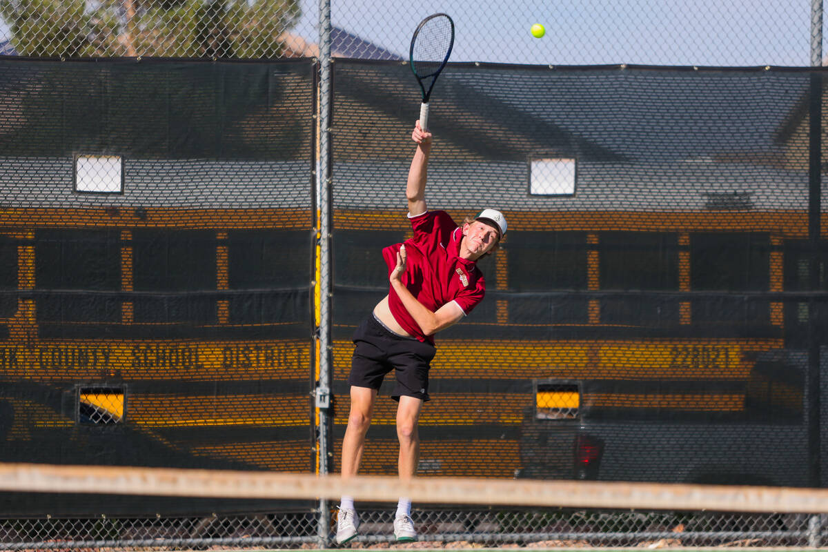 Faith Lutheran’s Sam Fouse slams the ball over the net during a 5A high school boys tenn ...