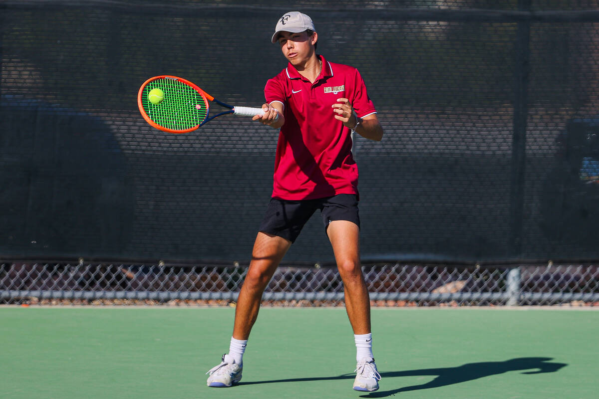 Faith Lutheran’s Beckham Butler hits the ball during a 5A high school boys tennis state champ ...