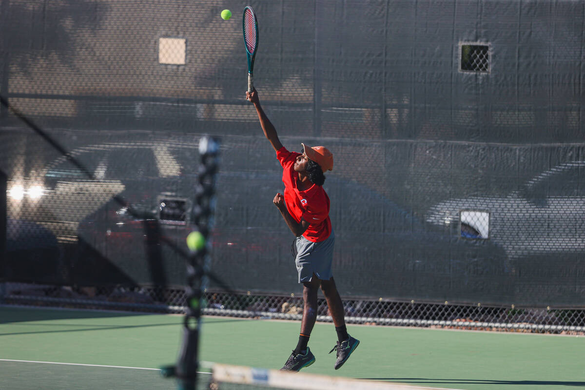 Coronado’s Ishaan Shorff raises his racket to hit the ball during a 5A high school boys ...