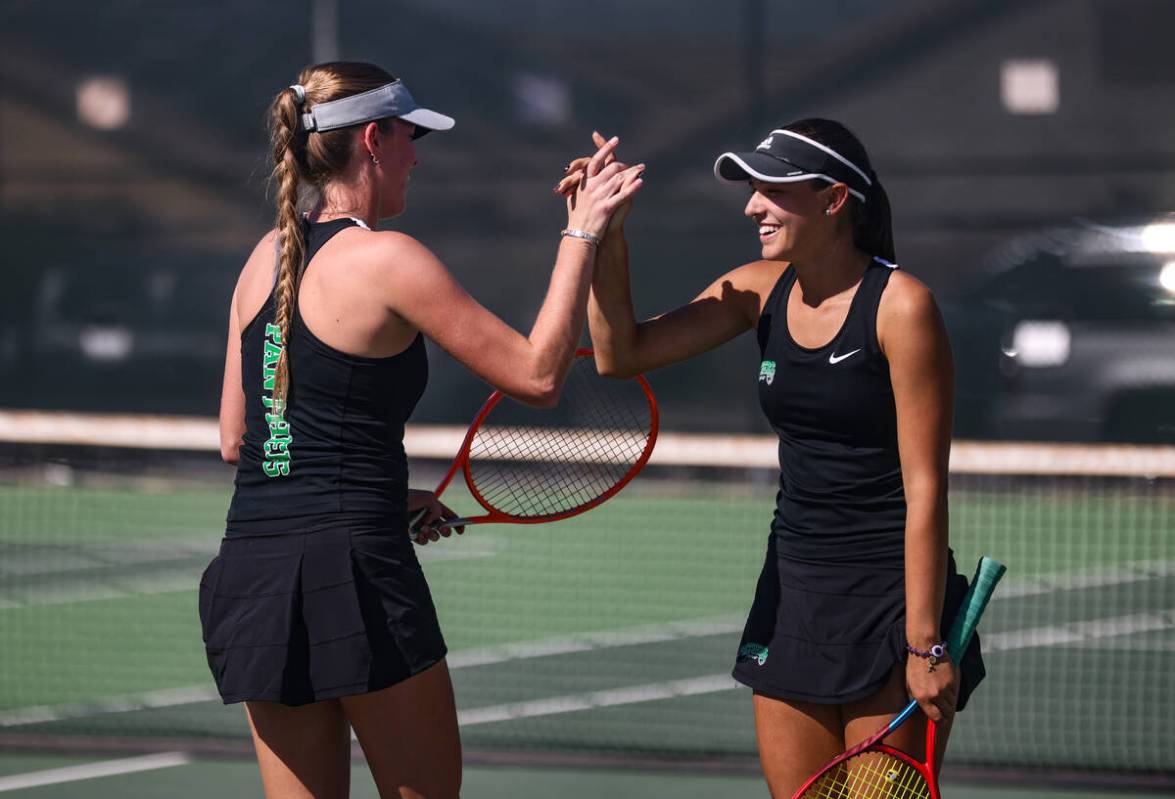 Palo Verde High School’s Milana Rybushkina high-fives her doubles partner Ruth Robison d ...