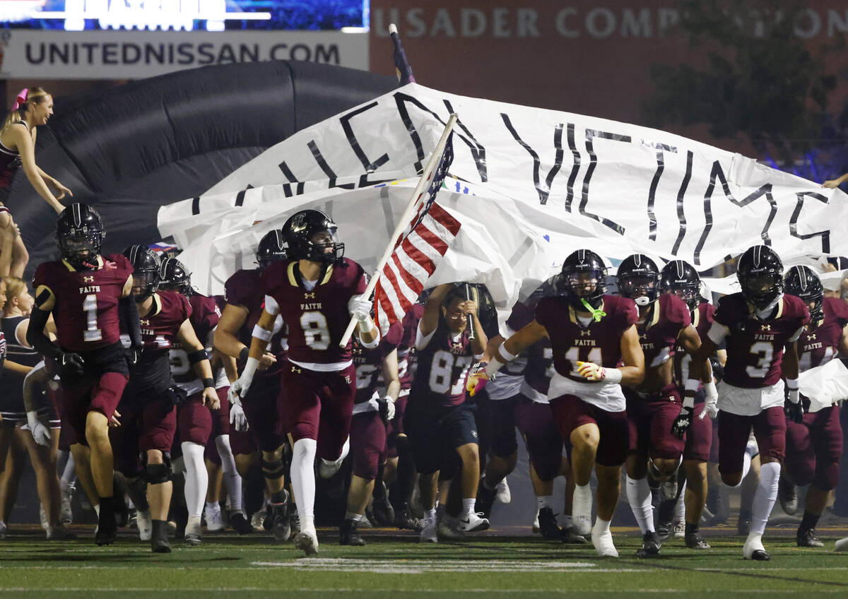 Faith Lutheran players take the field to face Legacy High during the high school football game ...