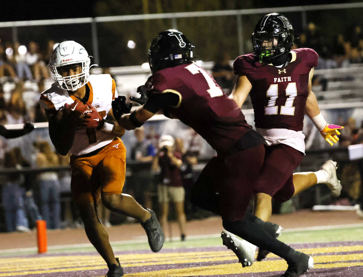 Legacy High's wide receiver Jordan Thompson-Woods (1) protects the ball from Faith Lutheran's d ...