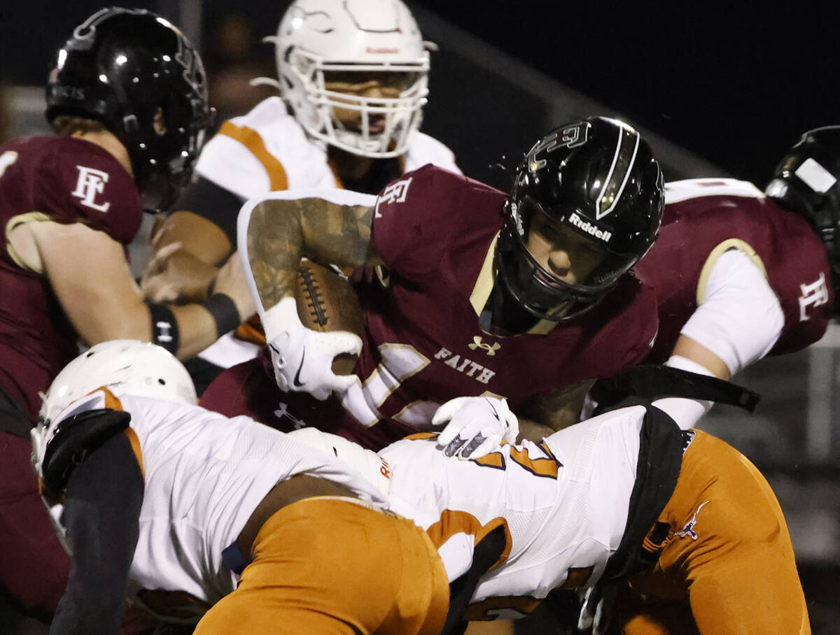 Legacy High's defense tackle Faith Lutheran's running back Cale Breslin (14) as he runs with th ...