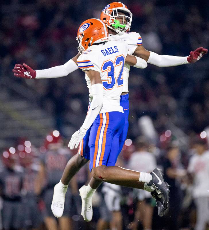 Bishop Gorman junior Jett Washington (5) and sophomore Hayden Stepp (32) celebrate a play durin ...