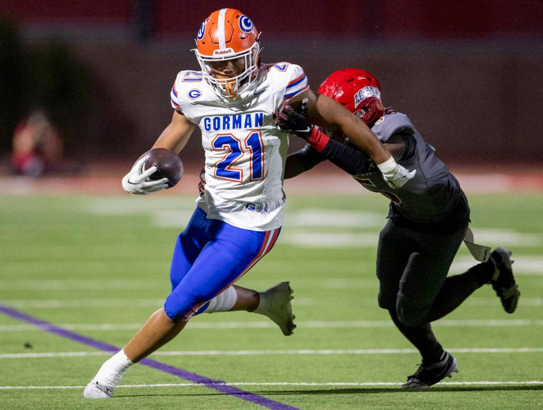 Bishop Gorman running back Jonathan Coar (21) avoids a tackle during the high school football g ...