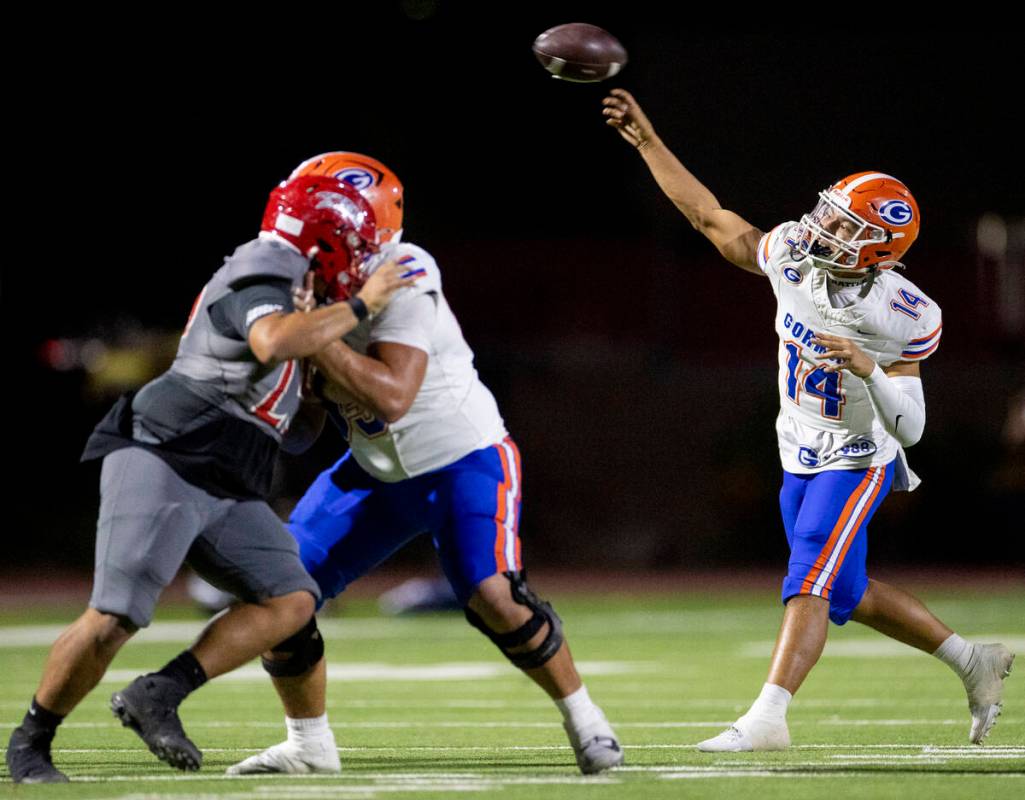 Bishop Gorman quarterback Maika Eugenio (14) throws the ball during the high school football ga ...