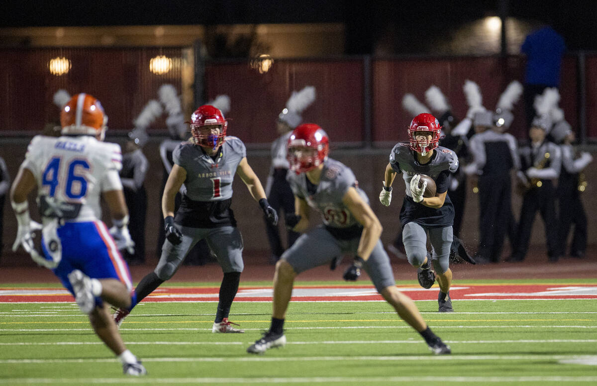 Arbor View wide receiver Kai Cypher (9) runs with a punted ball during the high school football ...