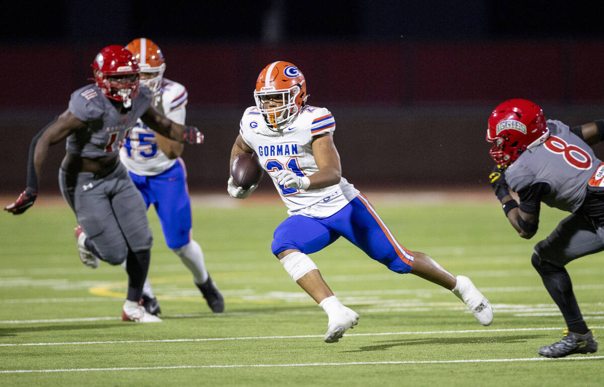 Bishop Gorman running back Jonathan Coar (21) runs the ball during the high school football gam ...