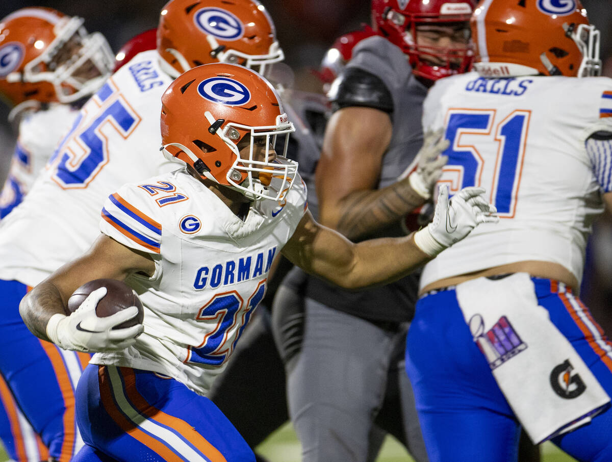 Bishop Gorman running back Jonathan Coar (21) runs the ball during the high school football gam ...