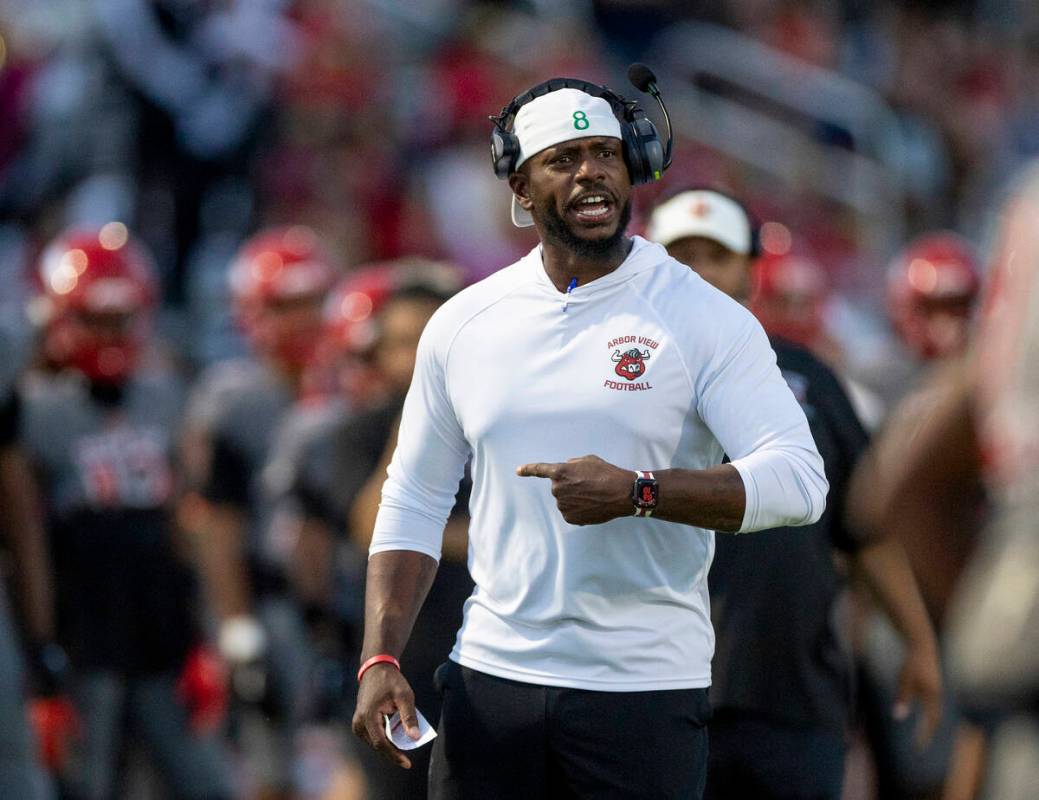 Arbor View Head Coach Marlon Barnett yells at his players during the high school football game ...