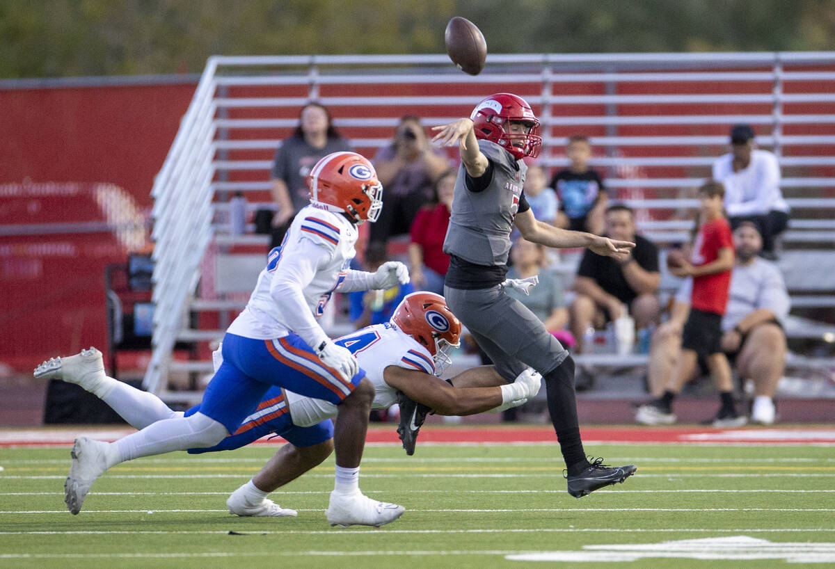 Arbor View quarterback Thaddeus Thatcher (7) gets rid of the football while being rushed during ...