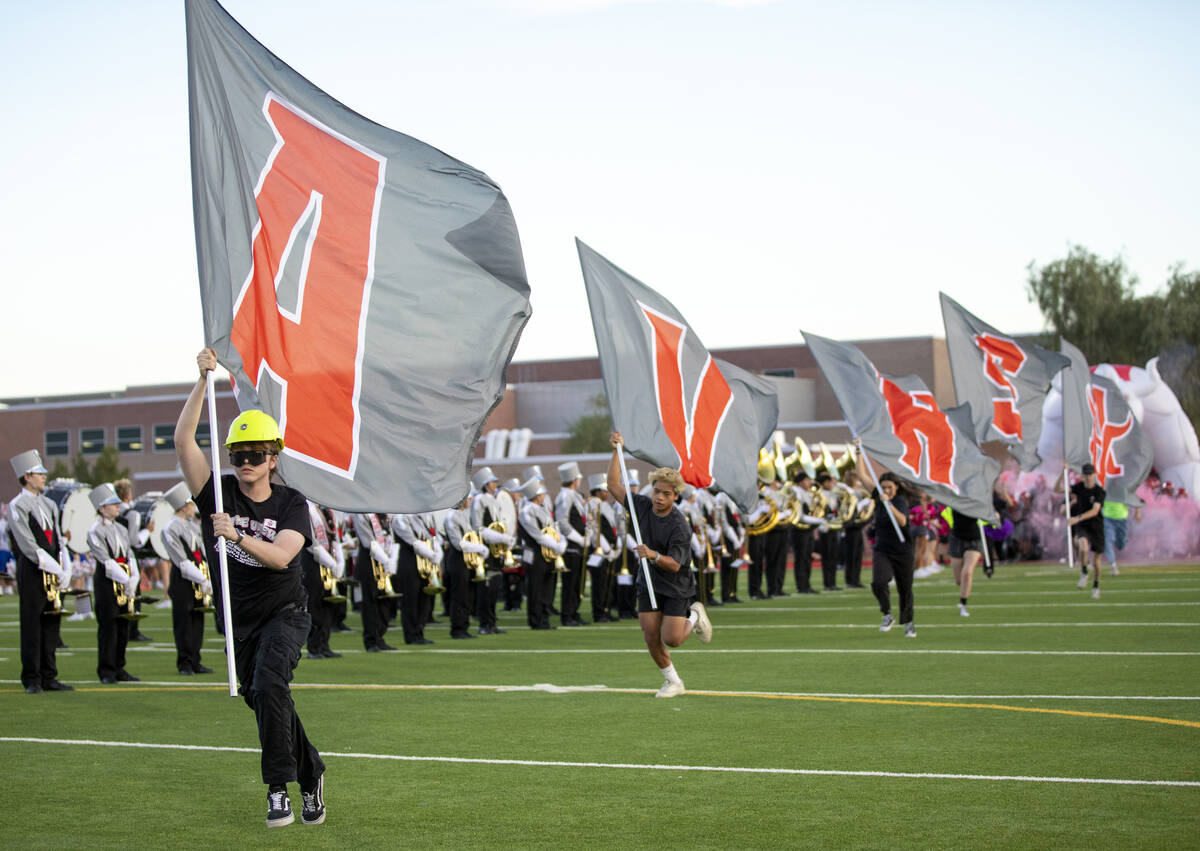 Student Arbor View leaders run with flags before the high school football game against Bishop G ...