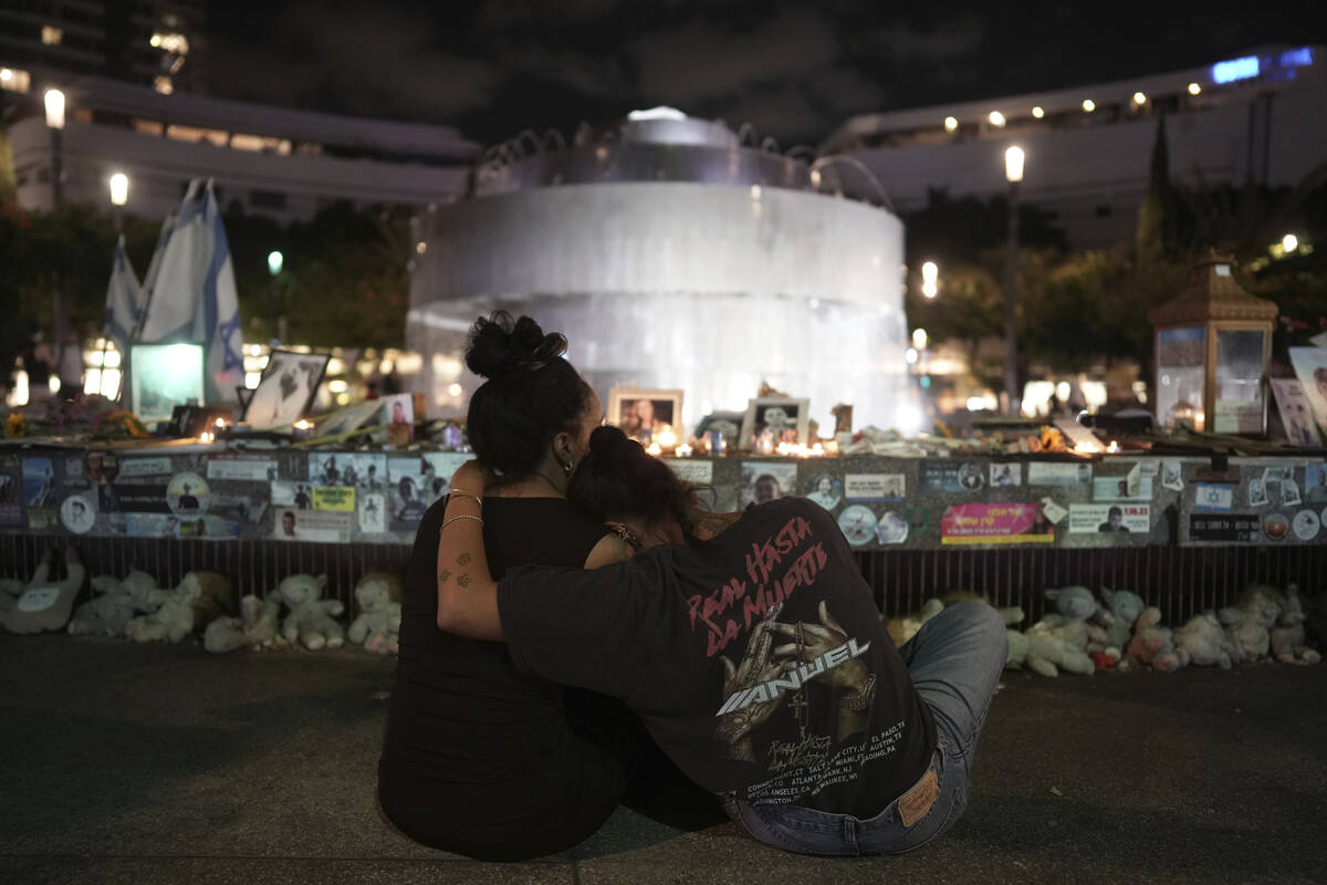 People visit a memorial marking the one-year anniversary of the Hamas attack on Israel, in Tel ...