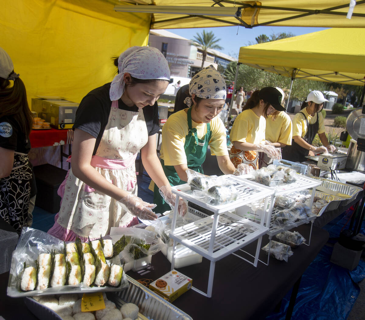 Ookini workers package food during the Aki Matsuri Japanese Festival at Water Street Plaza, Sat ...