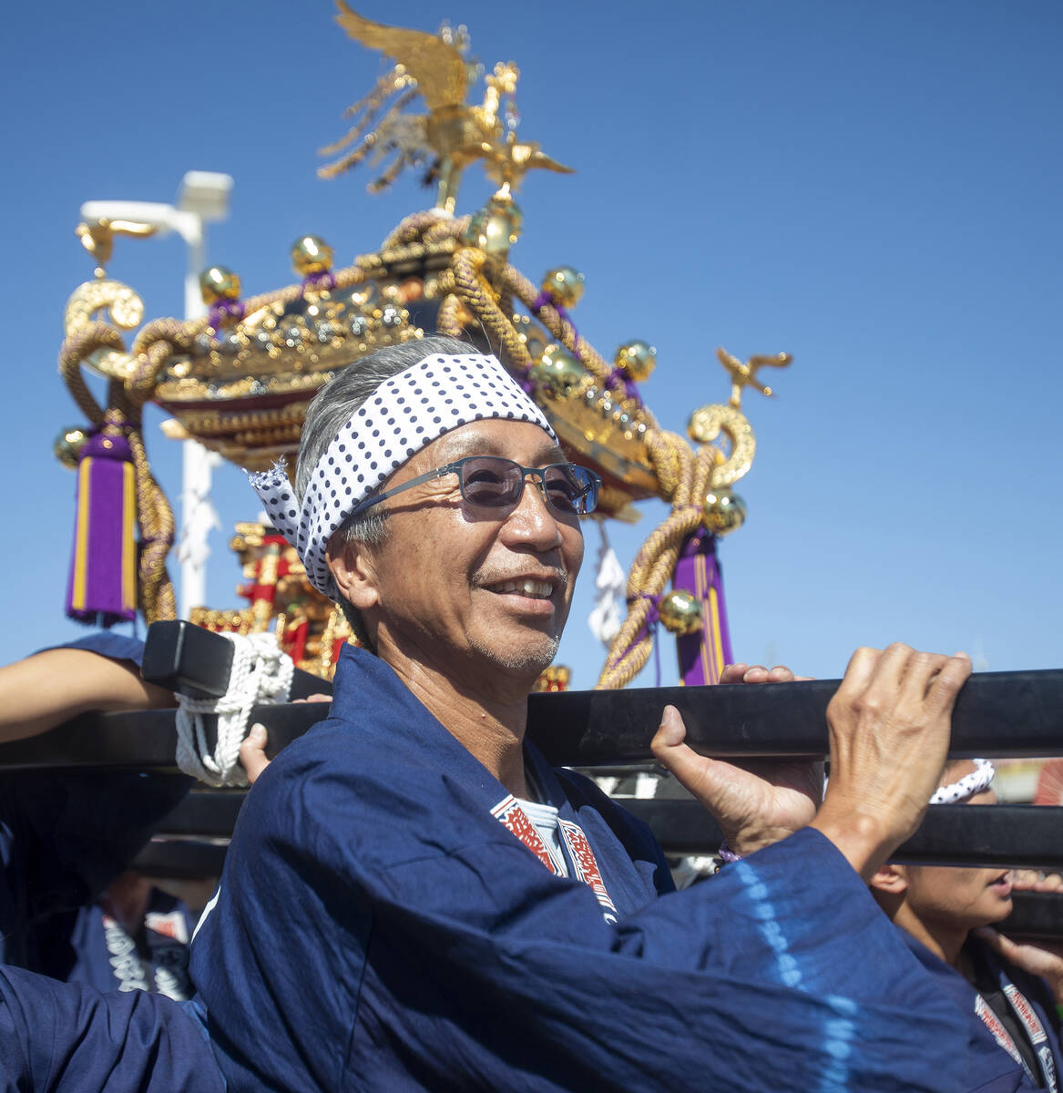 Tak Ishidn, the one who purchased the Mikoshi, helps carry the shrine during the Aki Matsuri Ja ...