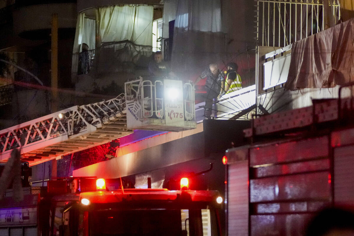 Emergency workers rescue an elderly man from a damaged building hit by an Israeli airstrike at ...