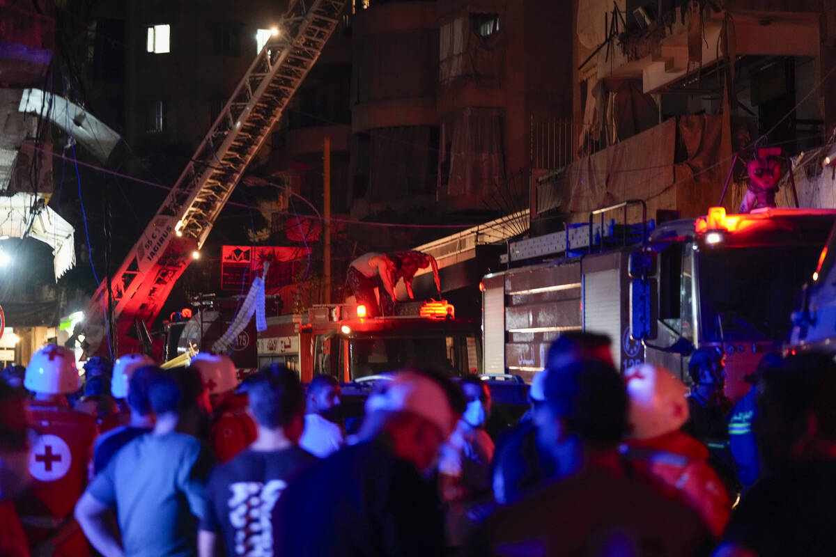 Paramedics and rescue workers work at the site of an Israeli airstrike in Beirut, Lebanon, Thur ...