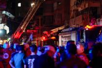 Paramedics and rescue workers work at the site of an Israeli airstrike in Beirut, Lebanon, Thur ...