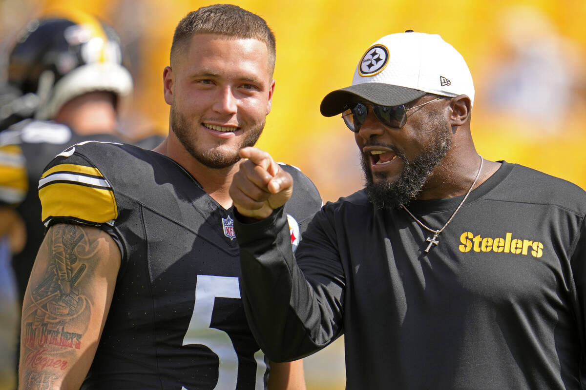 Pittsburgh Steelers linebacker Nick Herbig, left, listens to head coach Mike Tomlin during warm ...