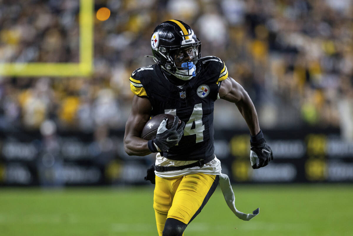 FILE - Pittsburgh Steelers wide receiver George Pickens (14) runs after a catch during an NFL f ...