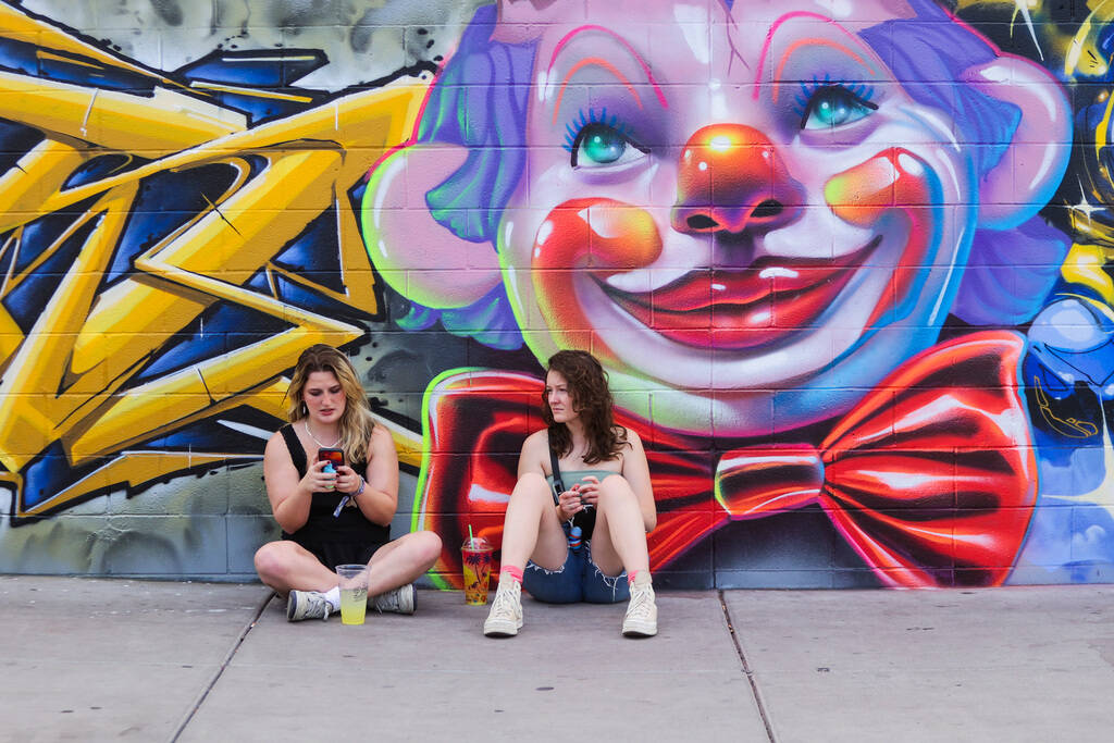 Festival attendees rest on the ground during the Best Friends Forever Festival at the Downtown ...