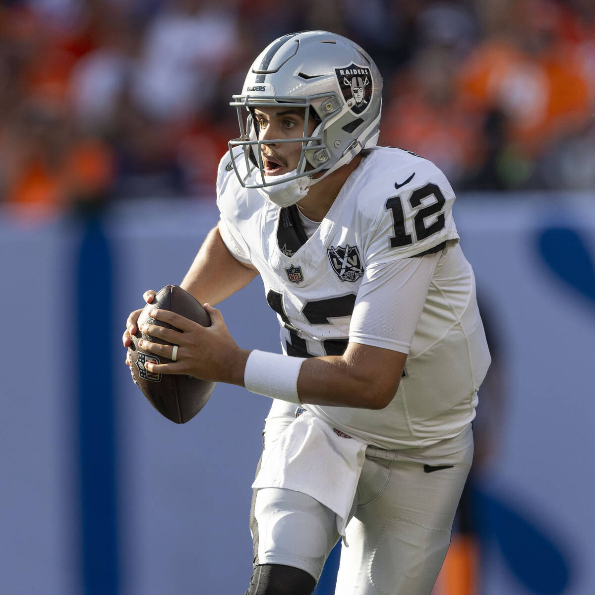 Raiders quarterback Aidan O'Connell (12) rushes with the football during the second half of an ...