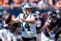 Carolina Panthers quarterback Andy Dalton looks to pass during an NFL football game against the ...