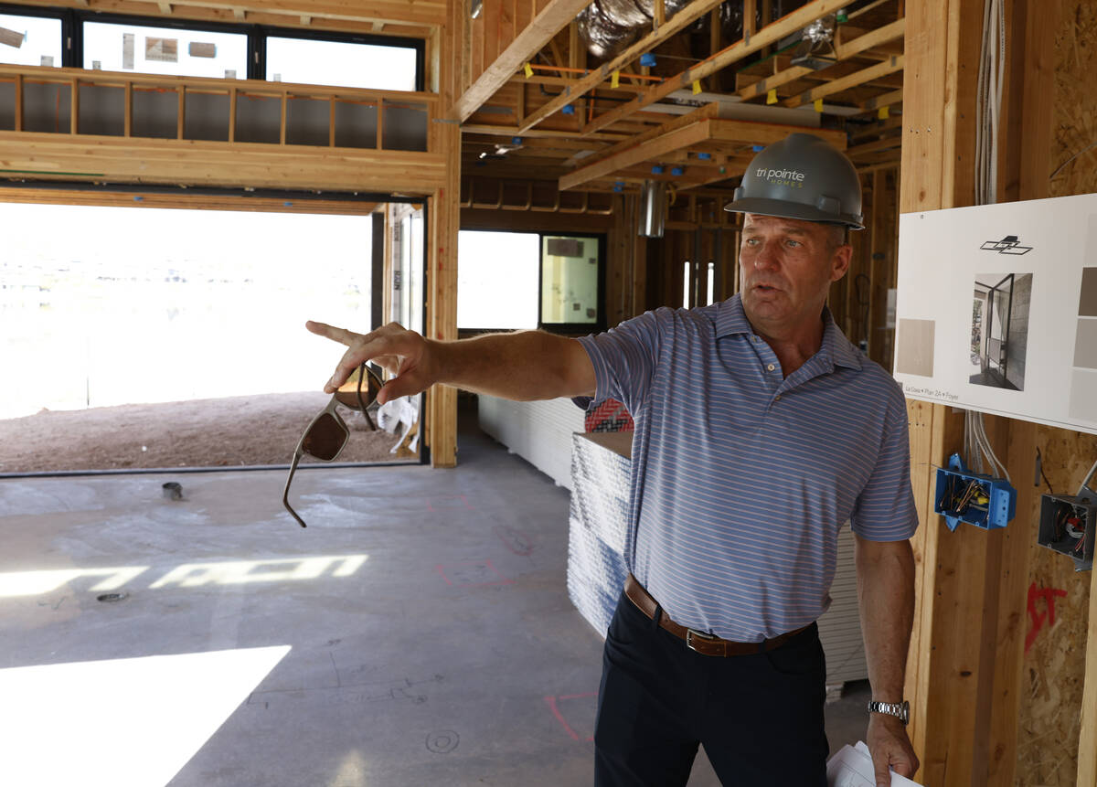 Klif Andrews, division president of Tri Pointe Homes Las Vegas, leads a tour of one of the two ...