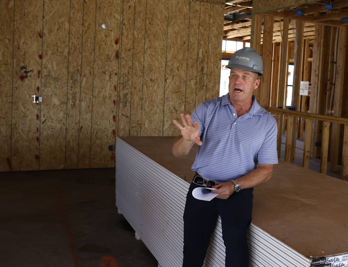 Klif Andrews, division president of Tri Pointe Homes Las Vegas, leads a tour of one of the two ...