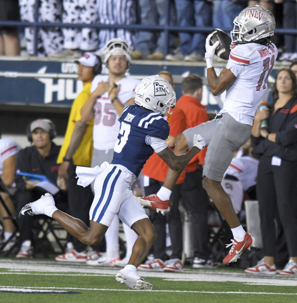 UNLV wide receiver Ricky White III (11) catches a pass as Utah State cornerback JD Drew (3) def ...