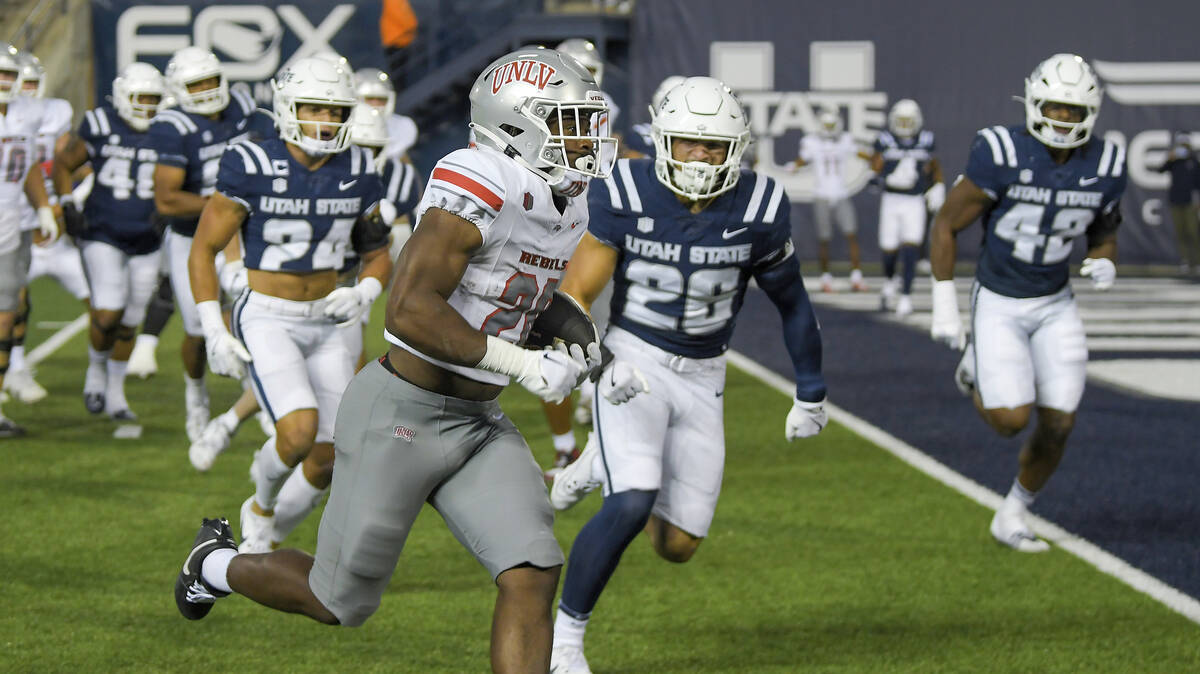 UNLV running back Kylin James, front left, carries the ball for a 5-yard touchdown against Utah ...