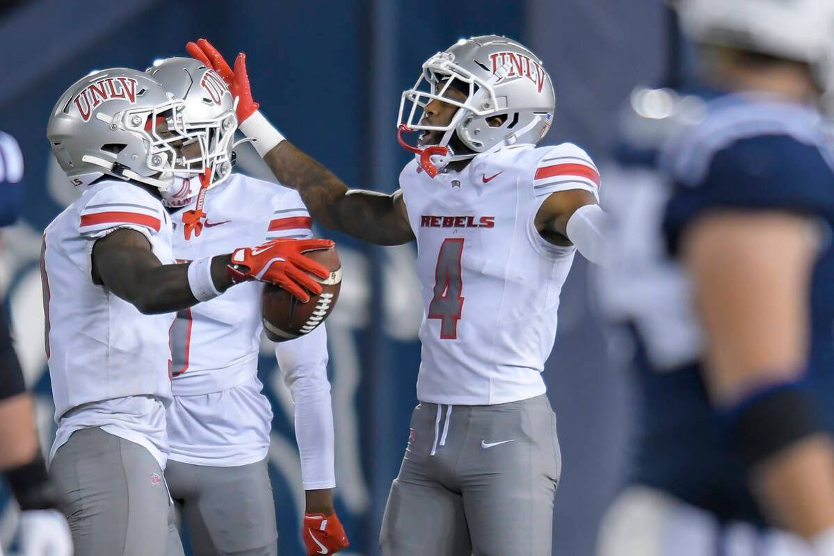 UNLV defensive back Jett Elad, left, celebrates with defensive back Malik Chavis (4) after inte ...