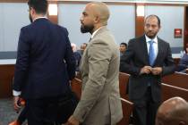 Sgt. Kevin Menon, center, who is charged with multiple counts of oppression under the color of ...