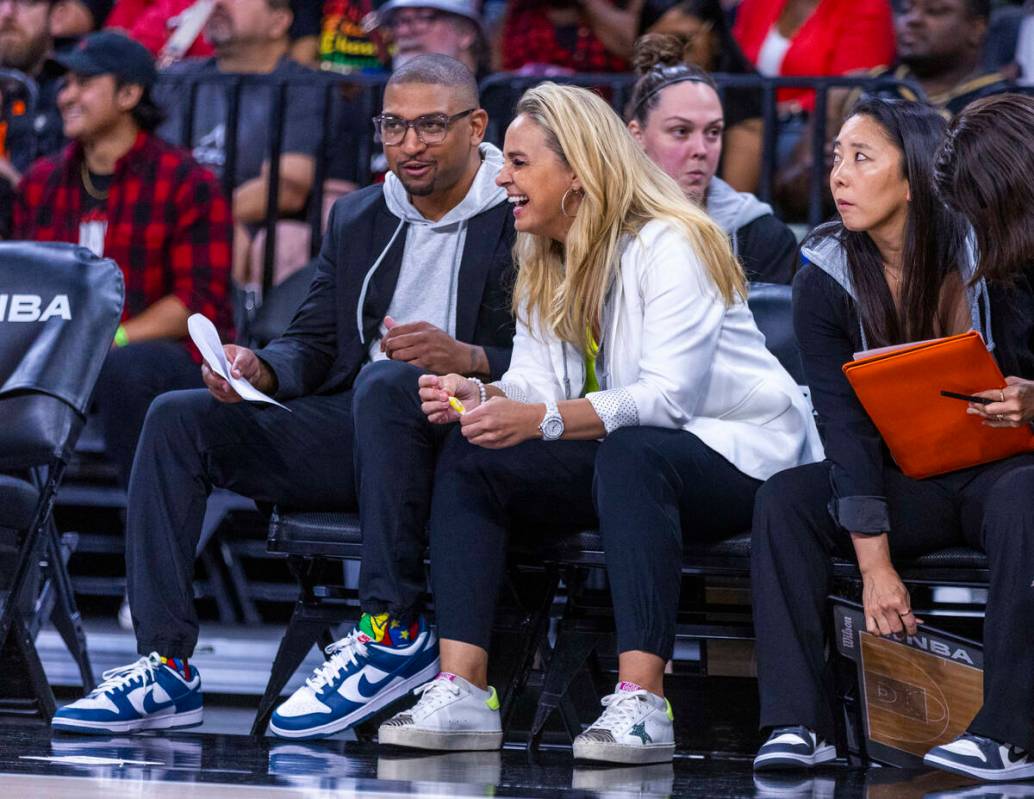 Aces head coach Becky Hammon laughs on the bench with assistant coach Tyler Marsh against ...