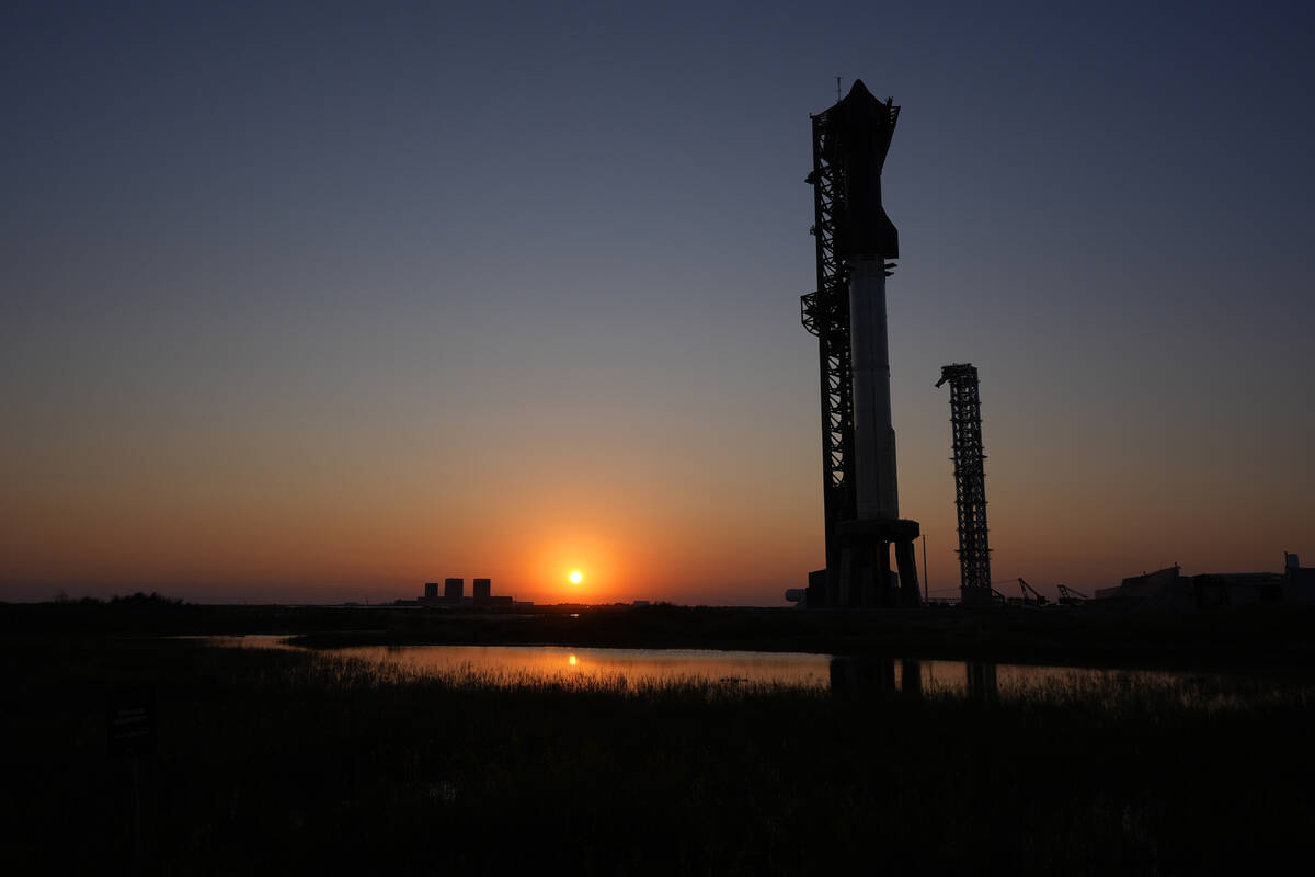 The sun sets behind SpaceX's mega rocket Starship, Saturday, Oct. 12, 2024, in Boca Chica, Texa ...