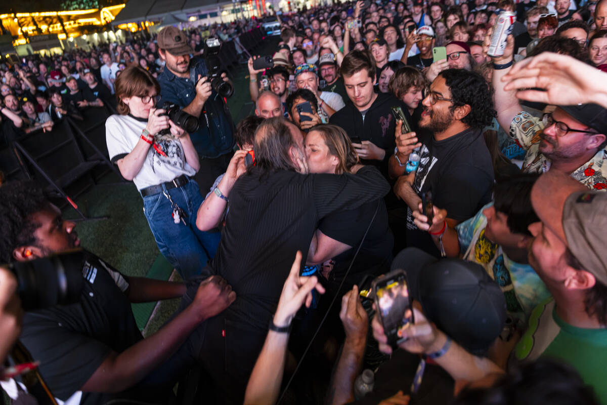 An audience member pulls David Yow of The Jesus Lizard in for a kiss during the final night of ...