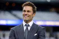 Fox Sports lead NFL analyst Tom Brady stands on the field during warmups before an NFL football ...