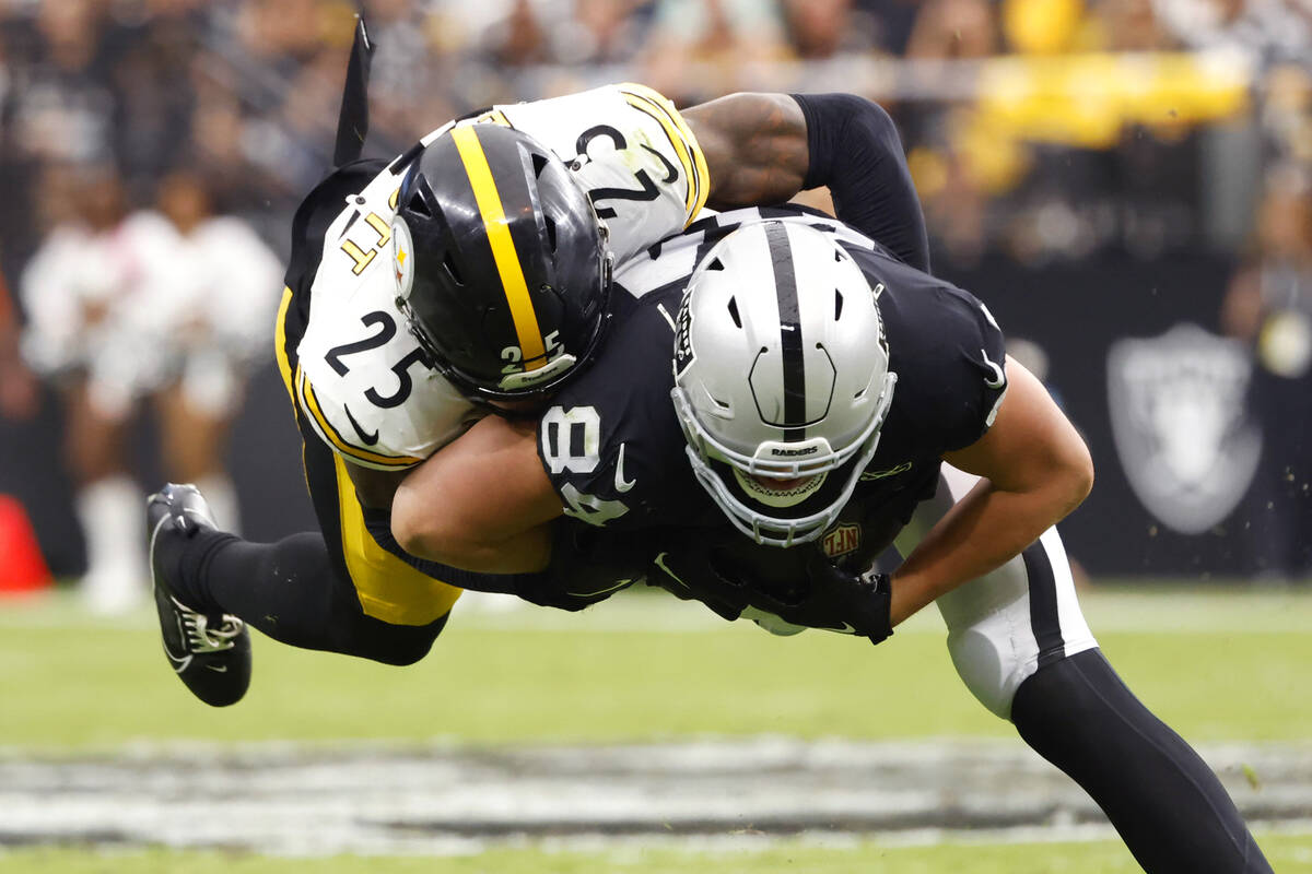 Raiders tight end Harrison Bryant (84) is taken down by Pittsburgh Steelers safety DeShon Ellio ...