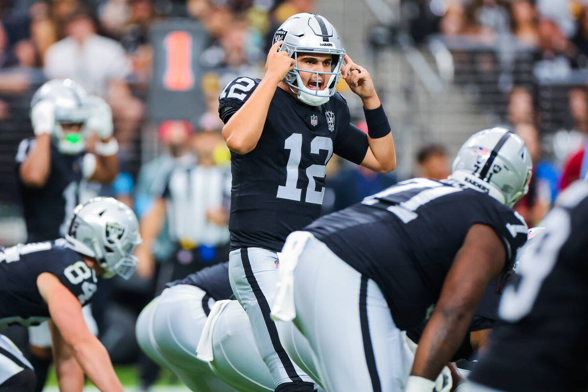 Raiders quarterback Aidan O'Connell (12) communicates to fellow players during the first half o ...