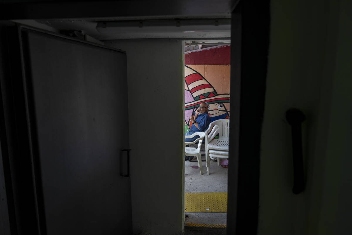 A man speaks on the phone in a public bomb shelter to stay safe from rockets fired from Lebanon ...