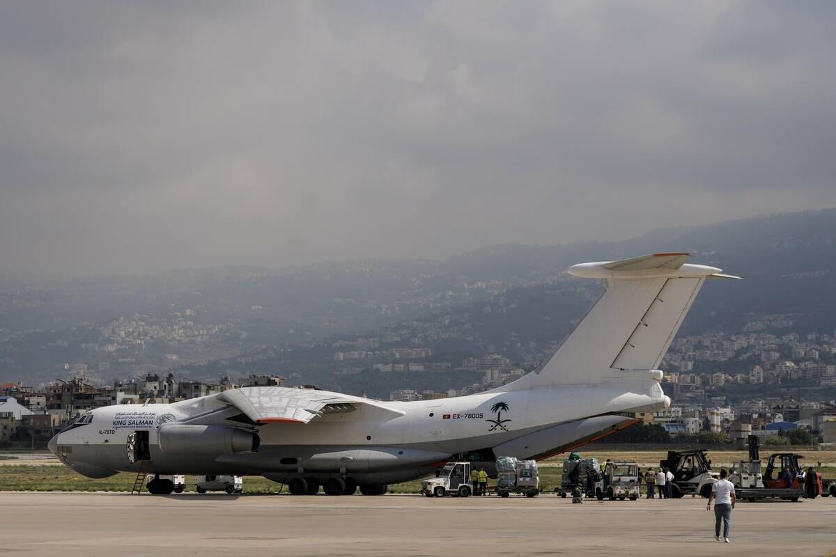 Workers unload Saudi medical aid boxes arriving at Beirut International airport, Lebanon, Sunda ...