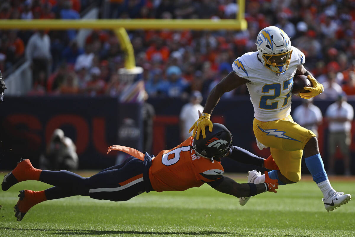 Los Angeles Chargers running back J.K. Dobbins (27) runs with the football as Denver Broncos sa ...