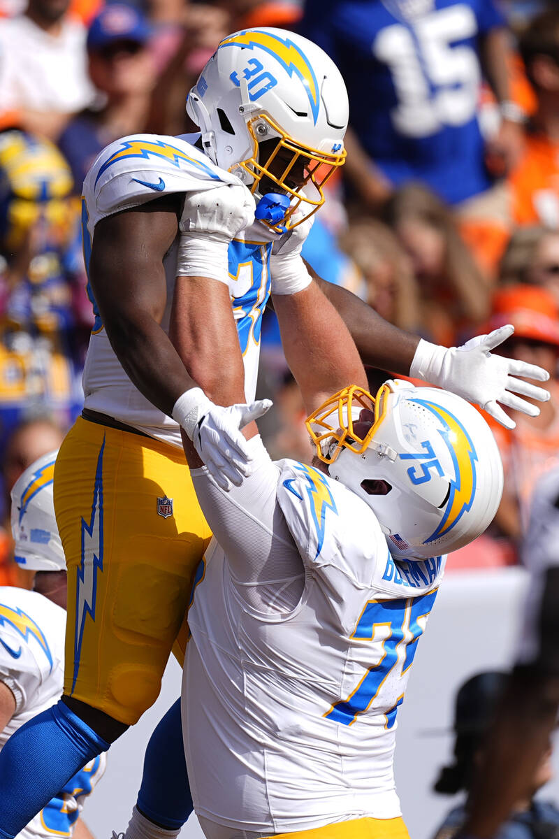 Los Angeles Chargers running back Kimani Vidal (30) celebrates with center Bradley Bozeman (75) ...