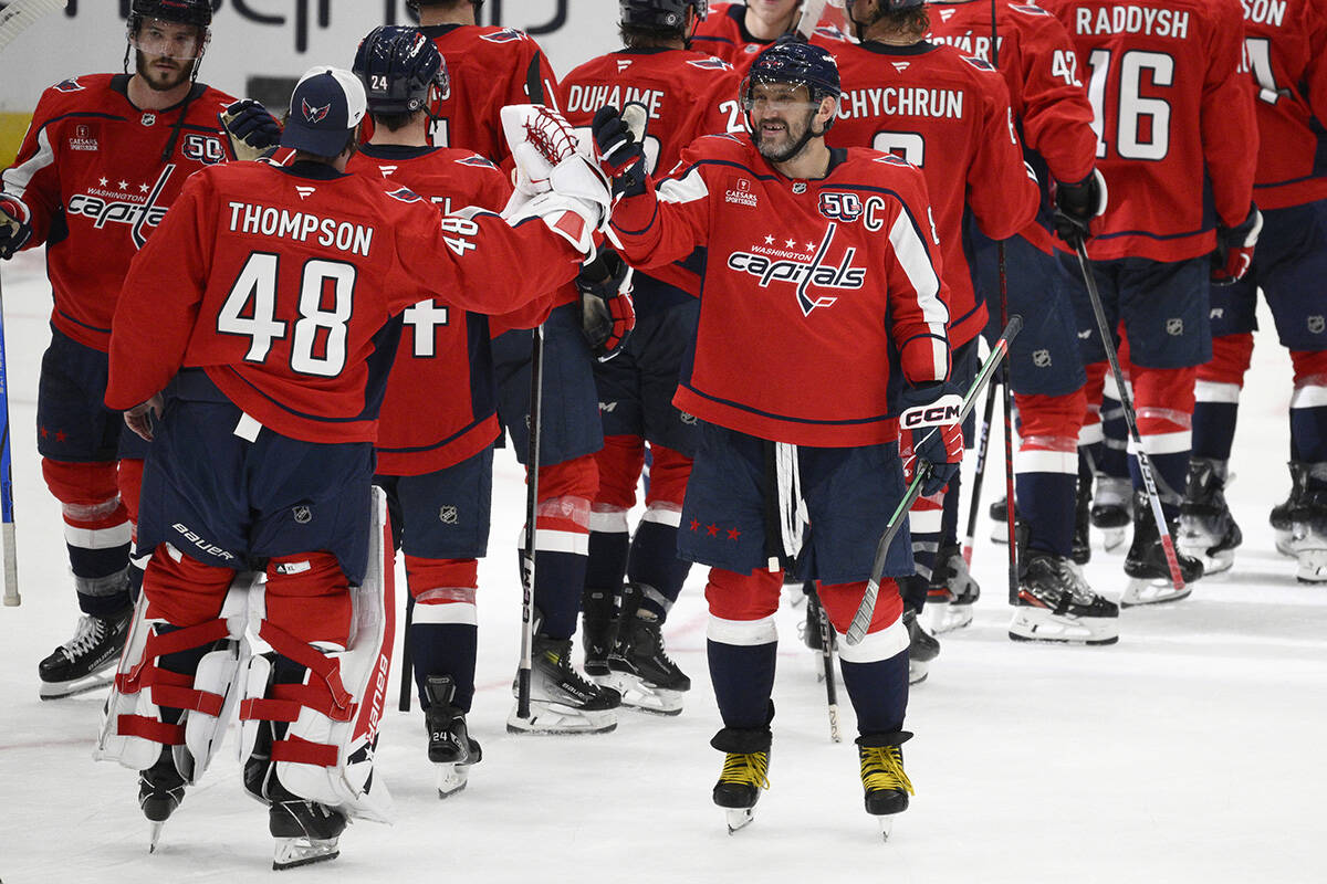 Washington Capitals left wing Alex Ovechkin, right, celebrates with Logan Thompson (48) after a ...